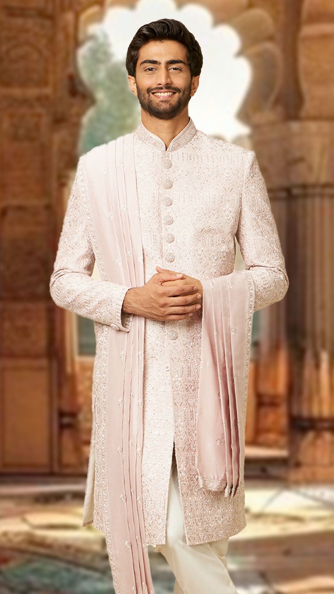 A groom in stylish pink sherwani for his wedding